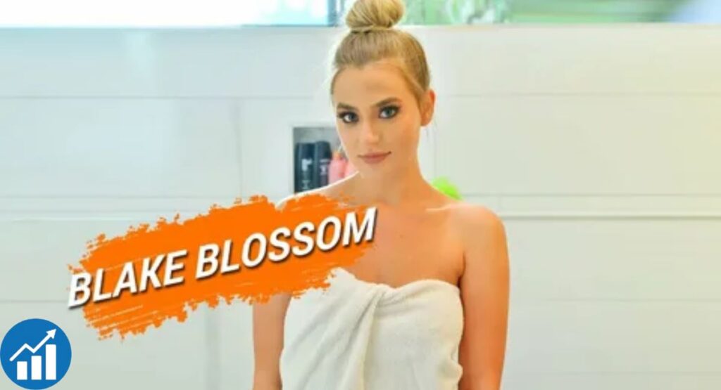 Blake Blossom posing in a studio setting wearing a black outfit