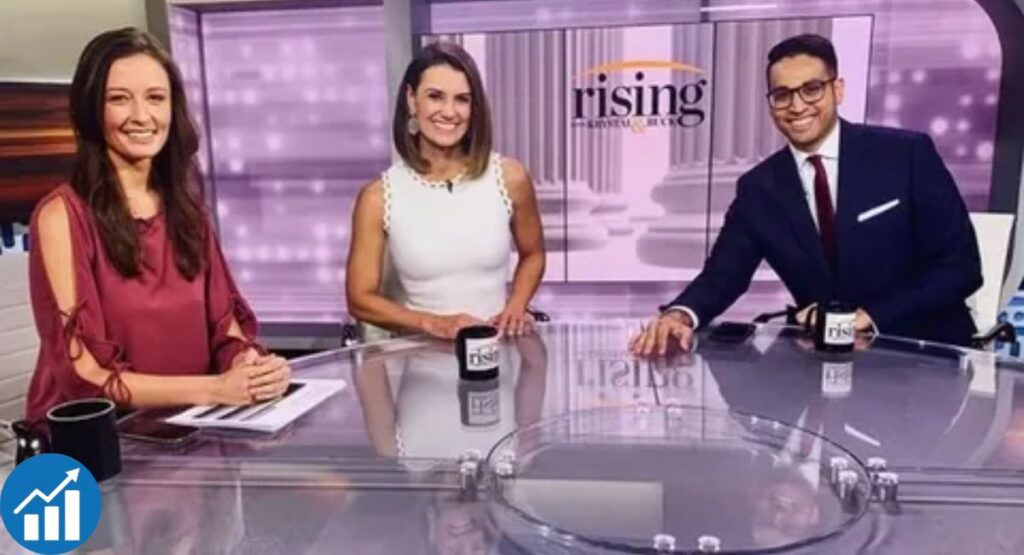 Emma Vigeland seated with Krystal Ball and Saagar Enjeti on the Rising news set, discussing political topics.