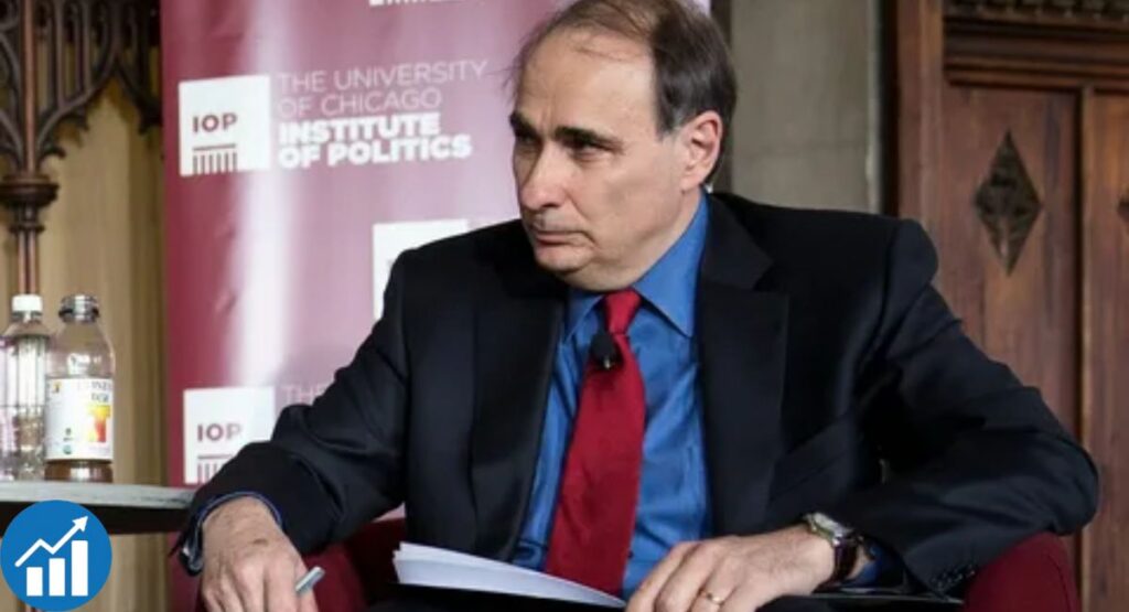 David Axelrod at a podium delivering a speech during a public event